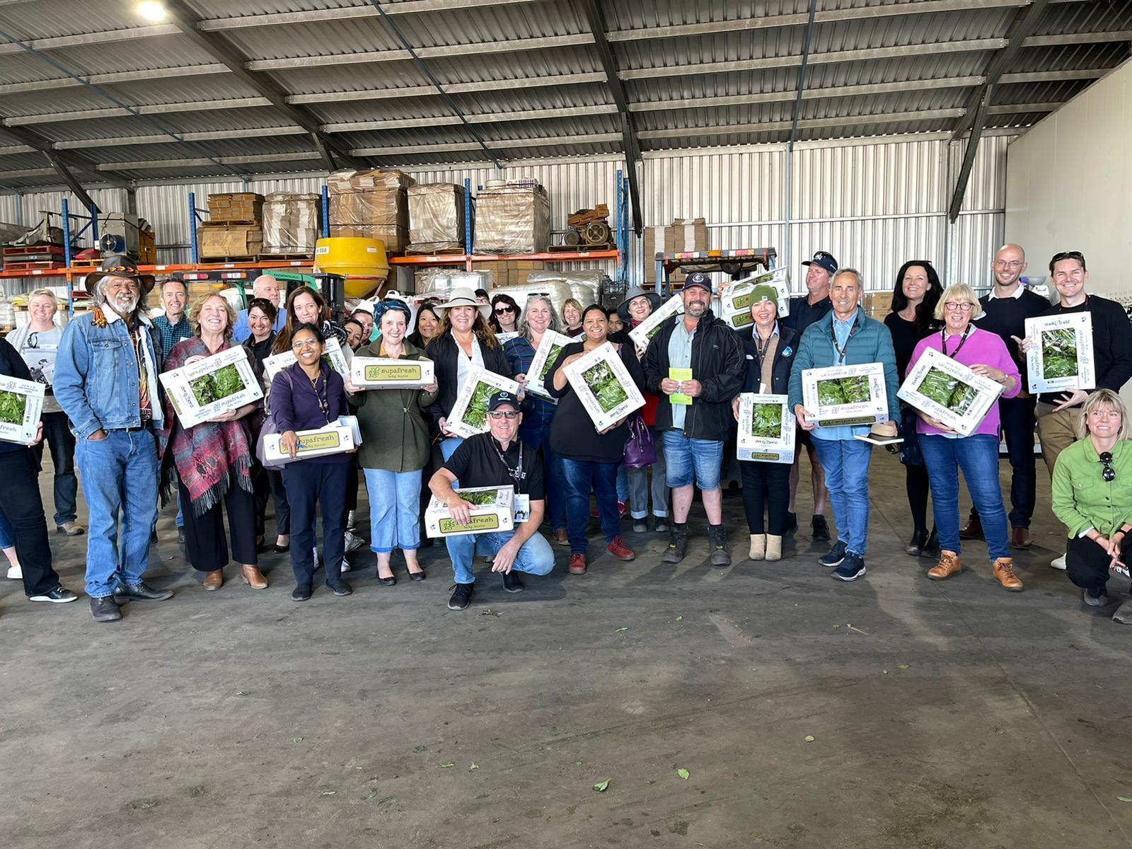 People from connected and resilient Food and Beverage industry holding up fresh produce